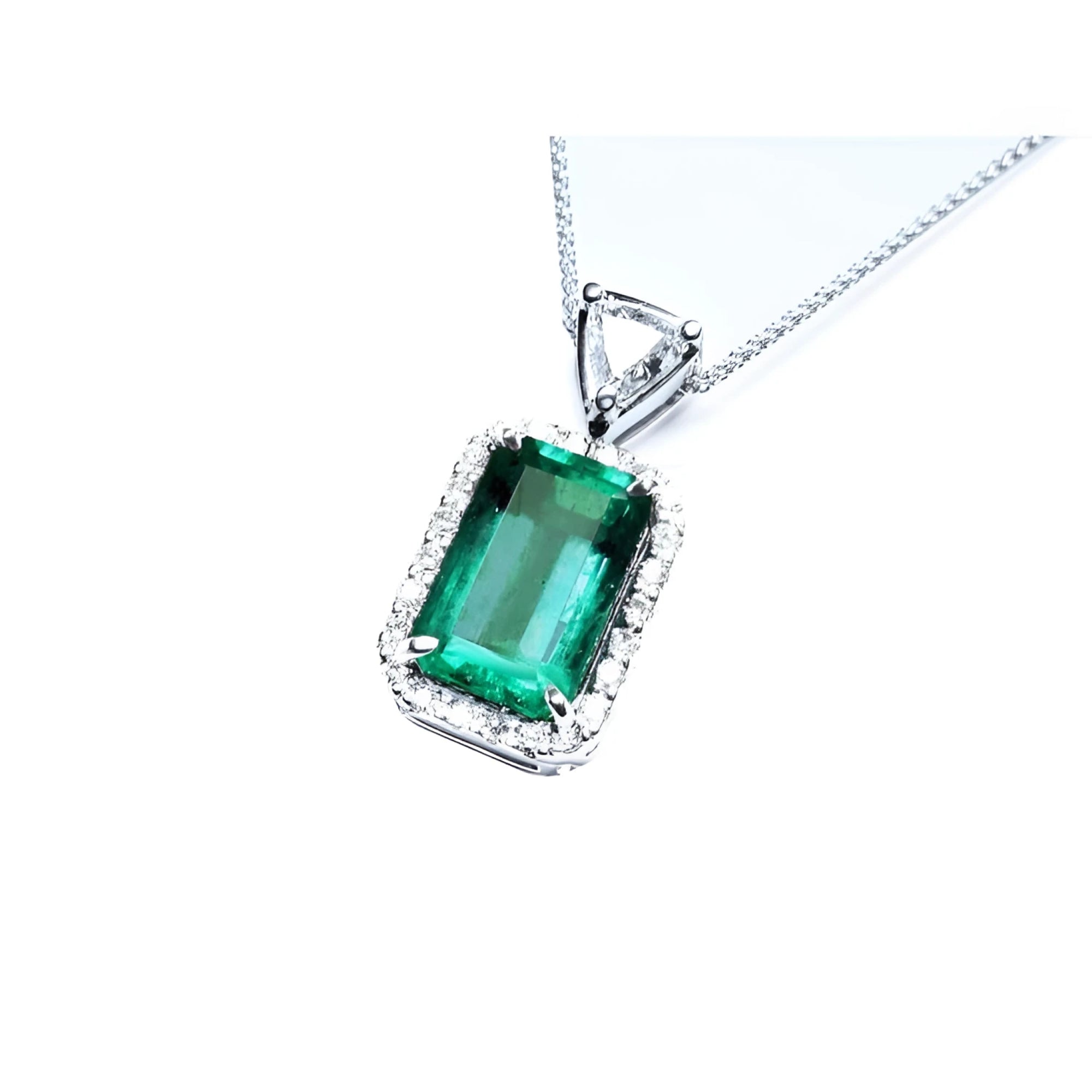 GIA certified Colombian emerald pendant with medium-deep green emerald-cut gem and diamond halo in 18K white gold.