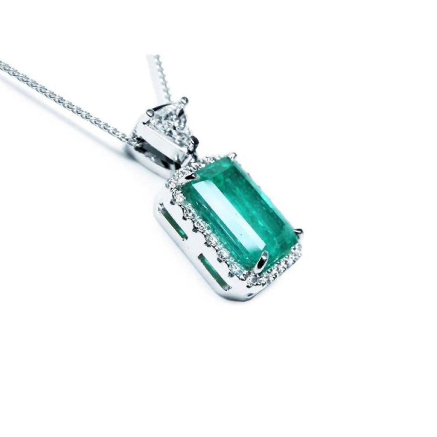 GIA certified 5.65 ct Colombian emerald pendant with medium-deep green emerald-cut gem and diamond halo in 18K white gold.
