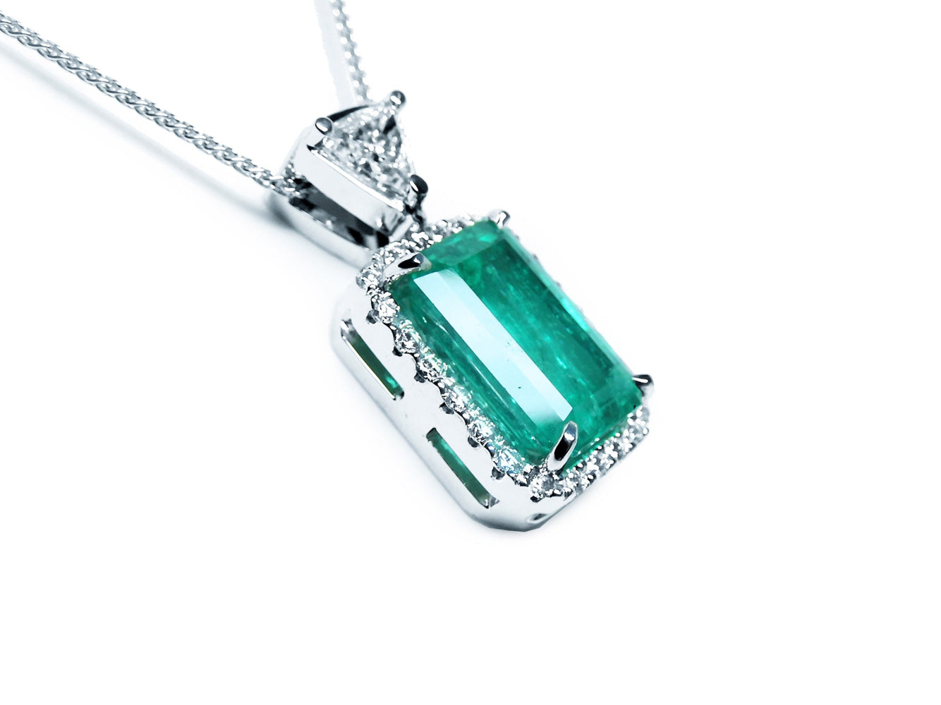 Emerald pendant necklace on a white background displaying the gallery perspective.
