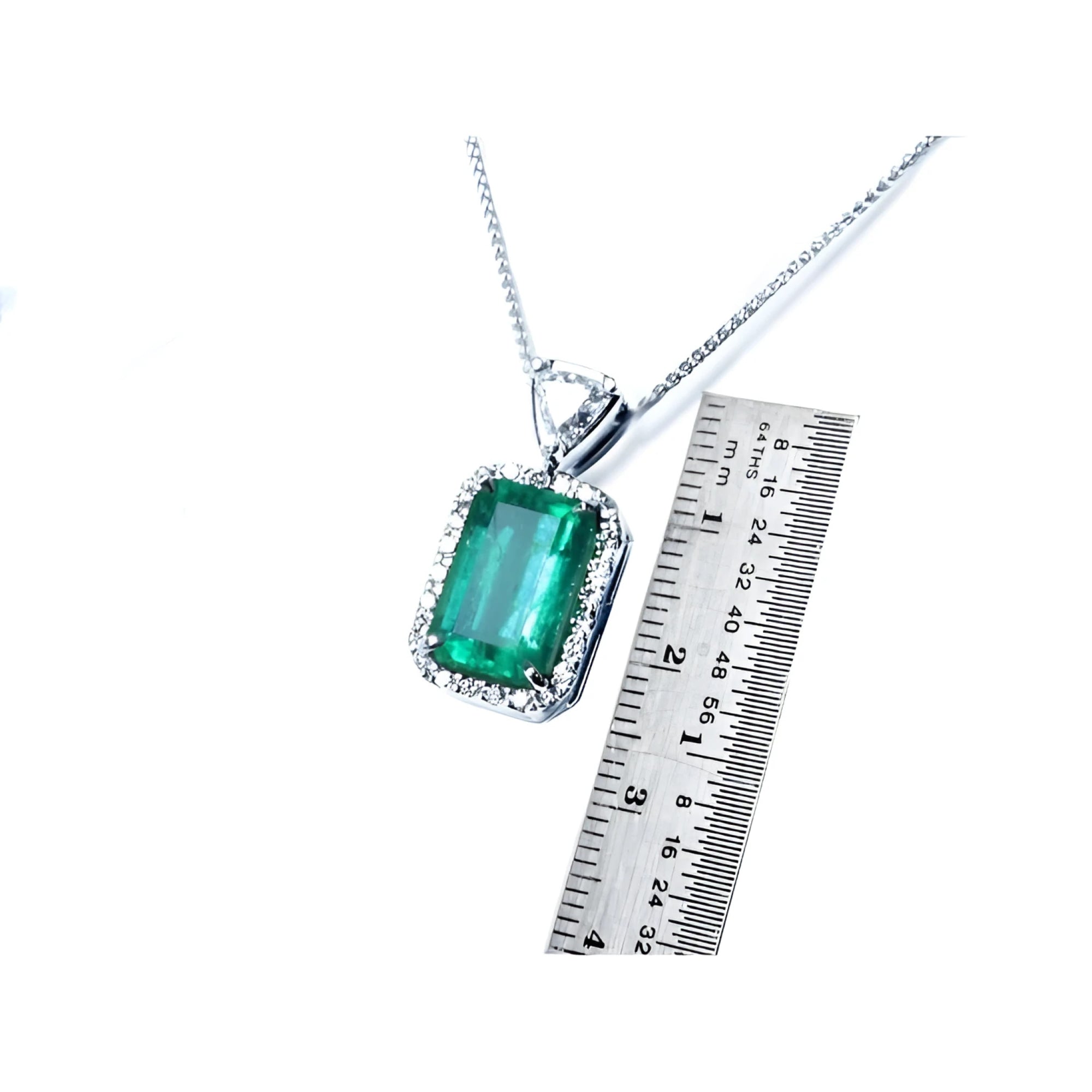 GIA certified 5.65 ct medium-deep green Colombian emerald pendant with diamond halo in 18K white gold.