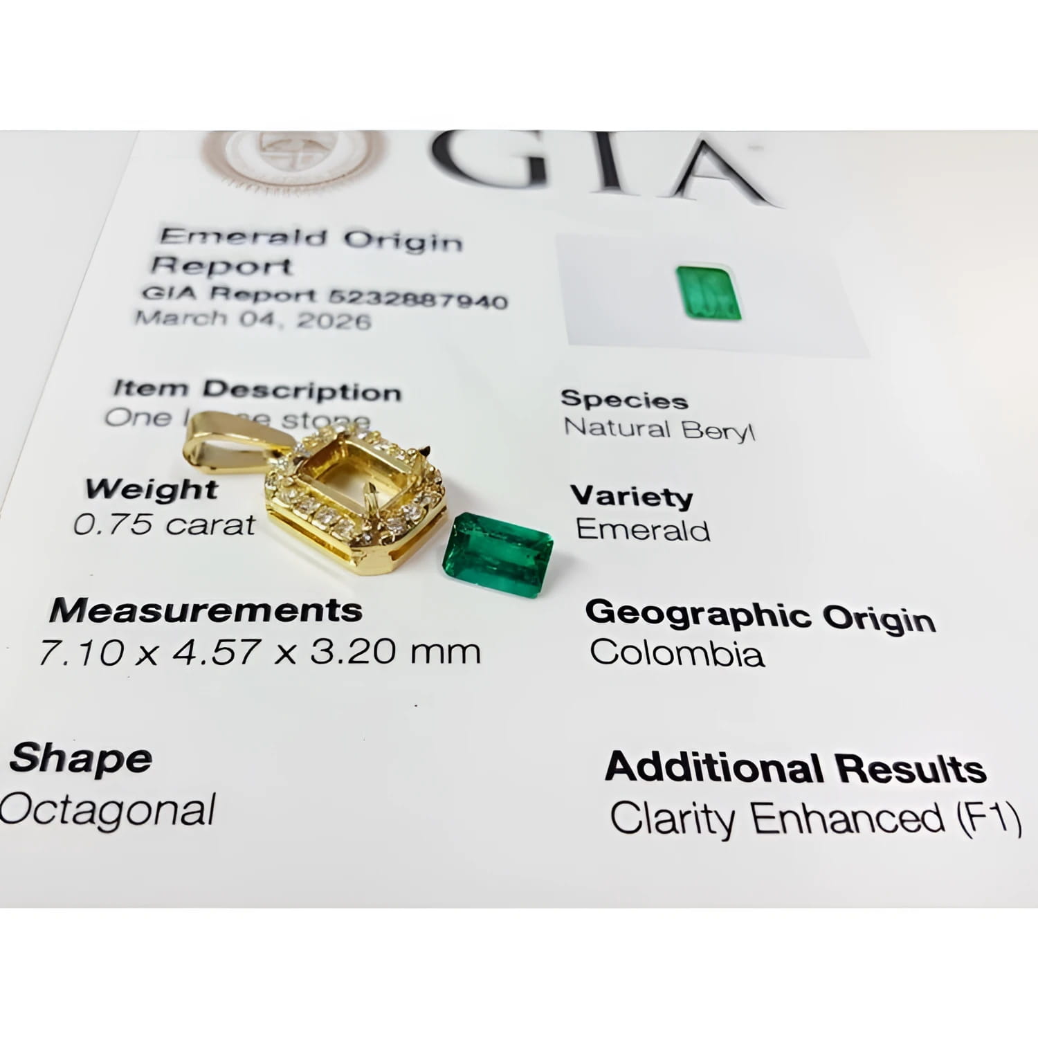 0.75 ct. GIA certified F1 Colombian emerald pendant in 18k gold with diamond halo, next to a loose emerald and GIA report.