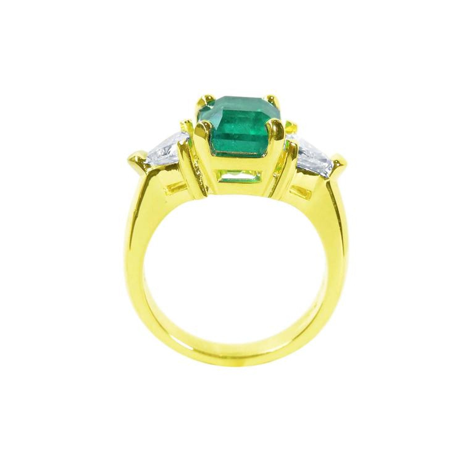 18K yellow gold ring with a GIA certified emerald and side trillion diamonds.