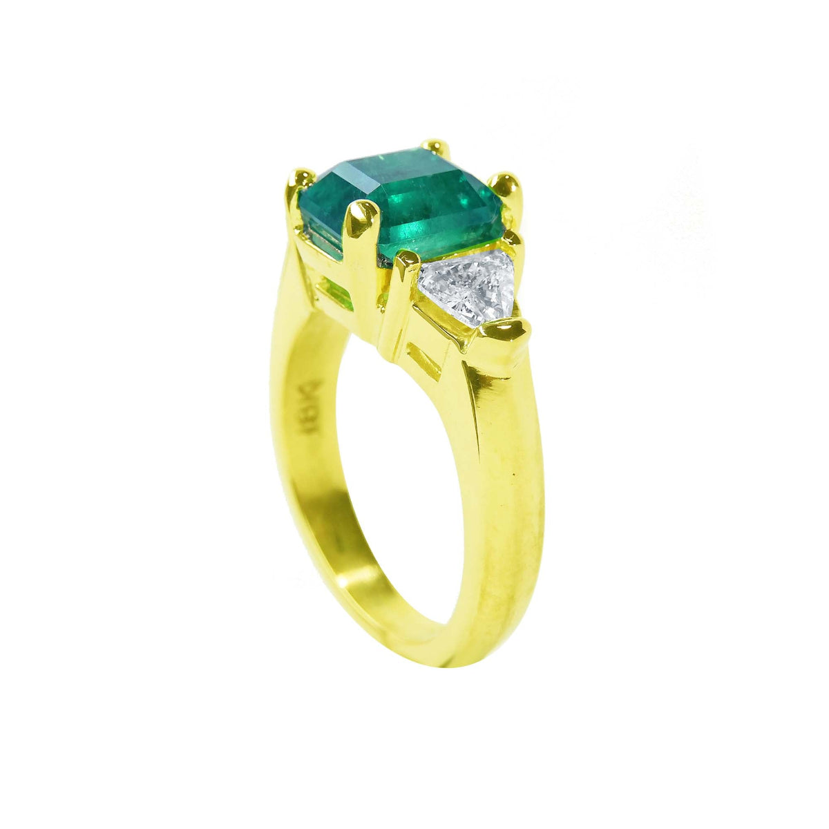 With side trillion cut diamonds a natural Muzo colombian emerald three stone ring 18k gold.