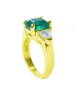 With side trillion cut diamonds a natural Muzo colombian emerald three stone ring 18k gold.