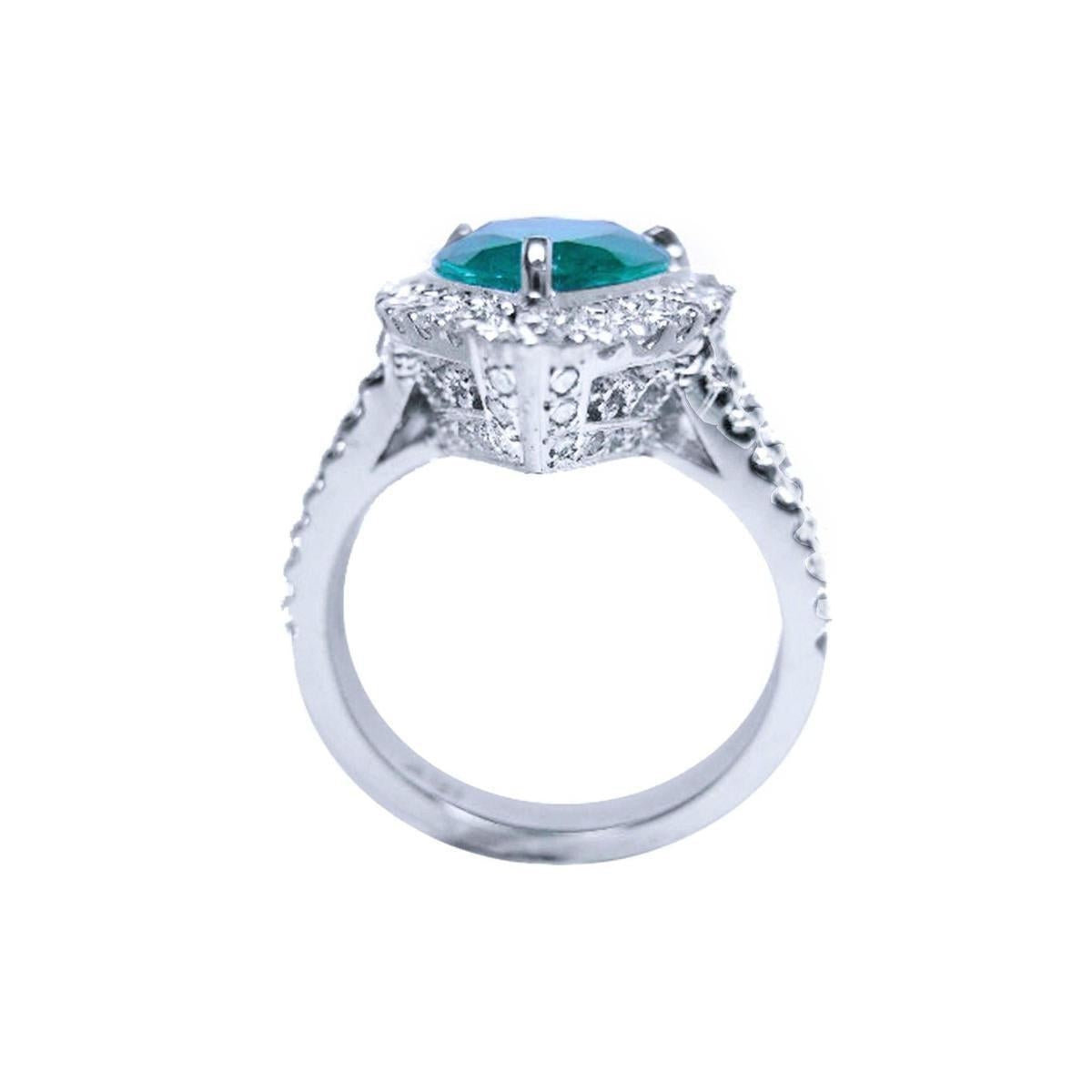 A natural teardrop emerald engagement ring, lateral gallery profile on a white background.