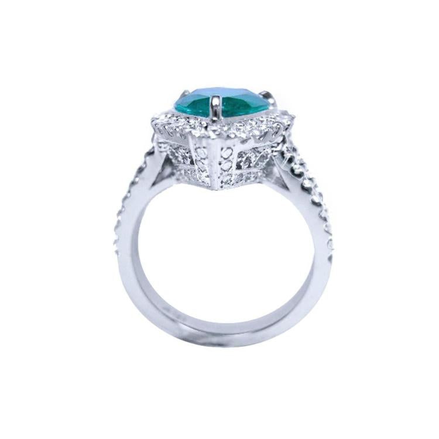 18K white gold ring with a pear-shaped deep bluish-green emerald surrounded by natural diamonds.