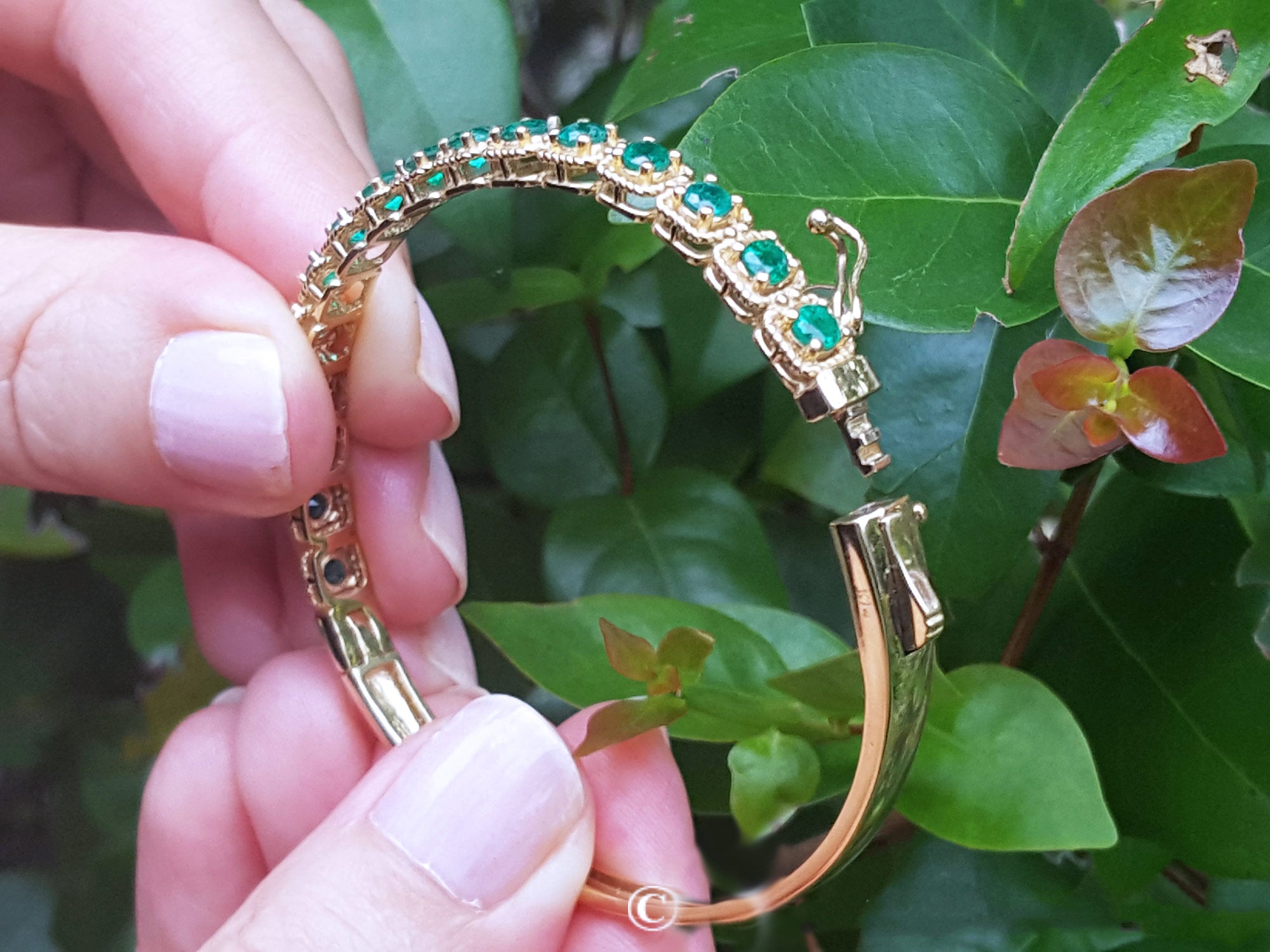 Yellow gold emerald bangle bracelets