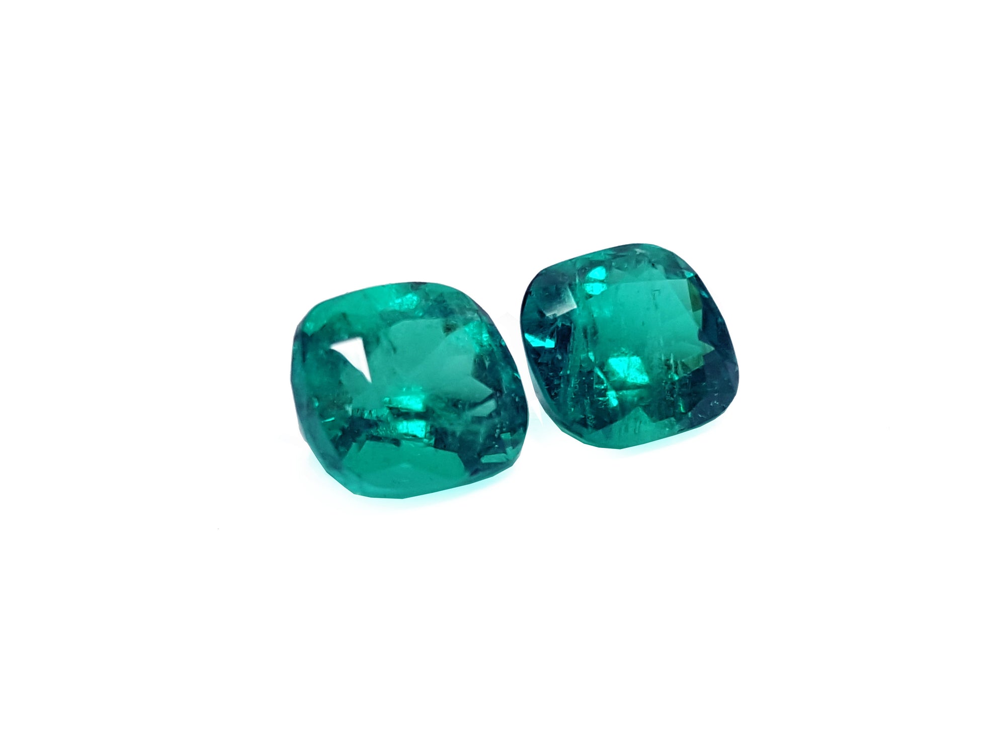 Matching pair cushion cut loose emeralds
