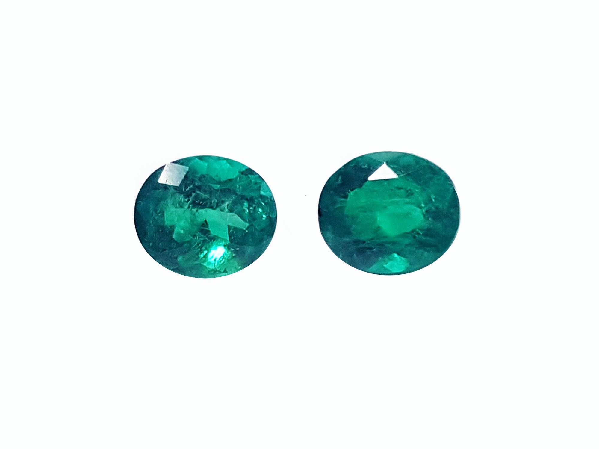 Oval cut patched pair loose emeralds