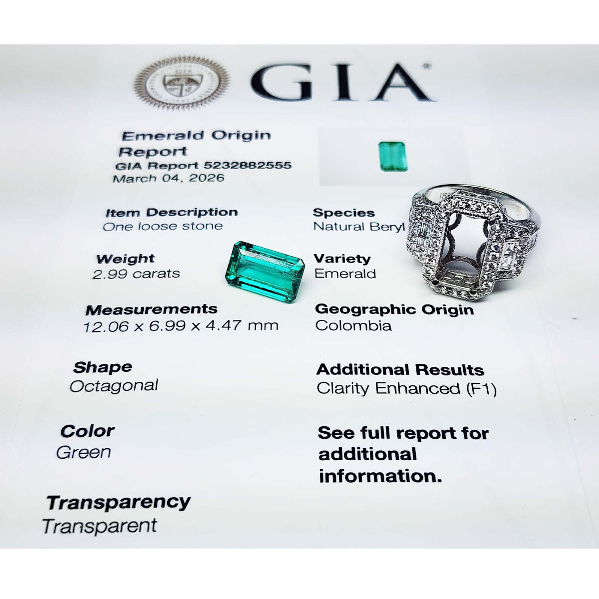 GIA emerald origin report with a loose emerald stone and ring on a white background.