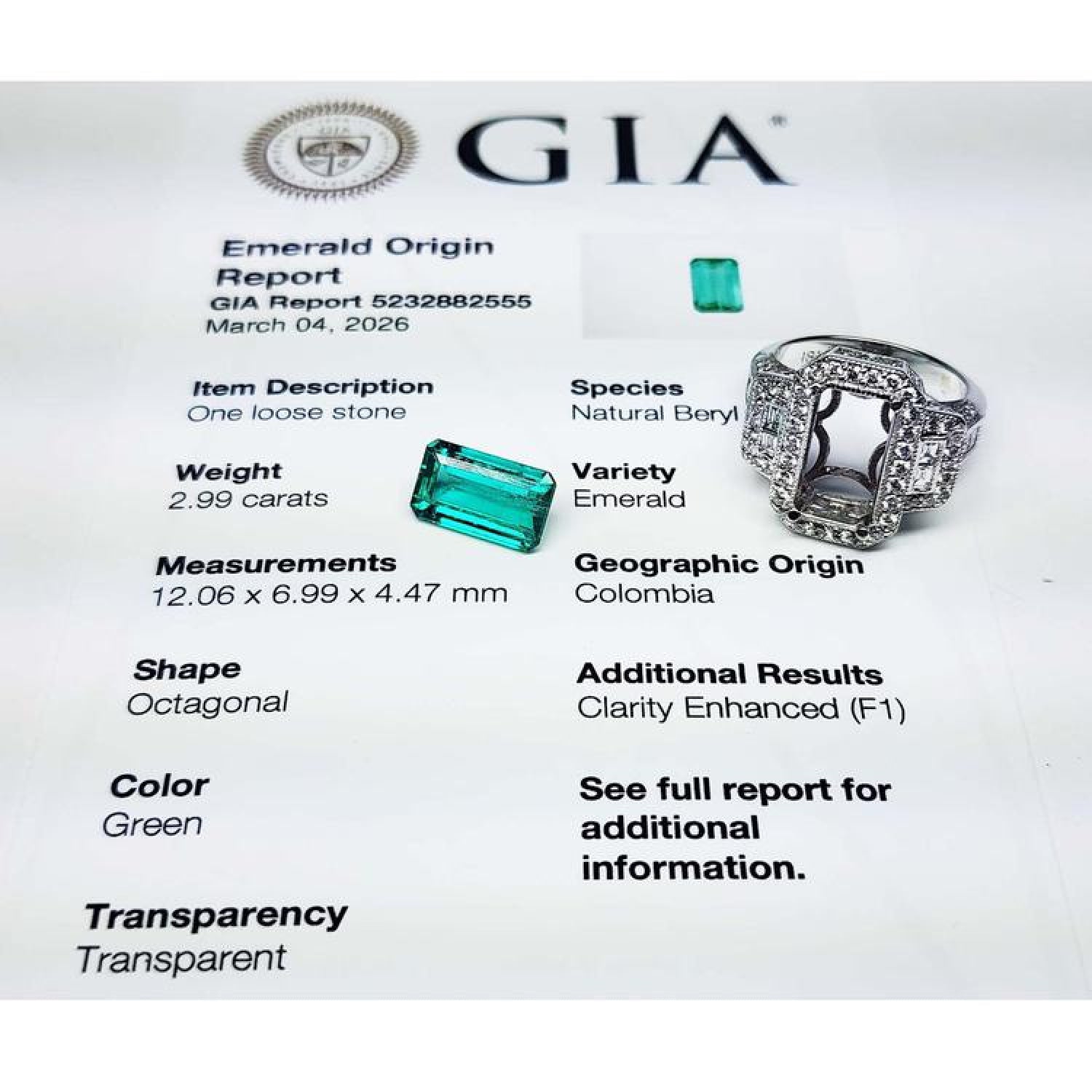 GIA certified 2.99 ct. F1 Colombian emerald ring in 18K white gold with diamond halo and baguette accents.