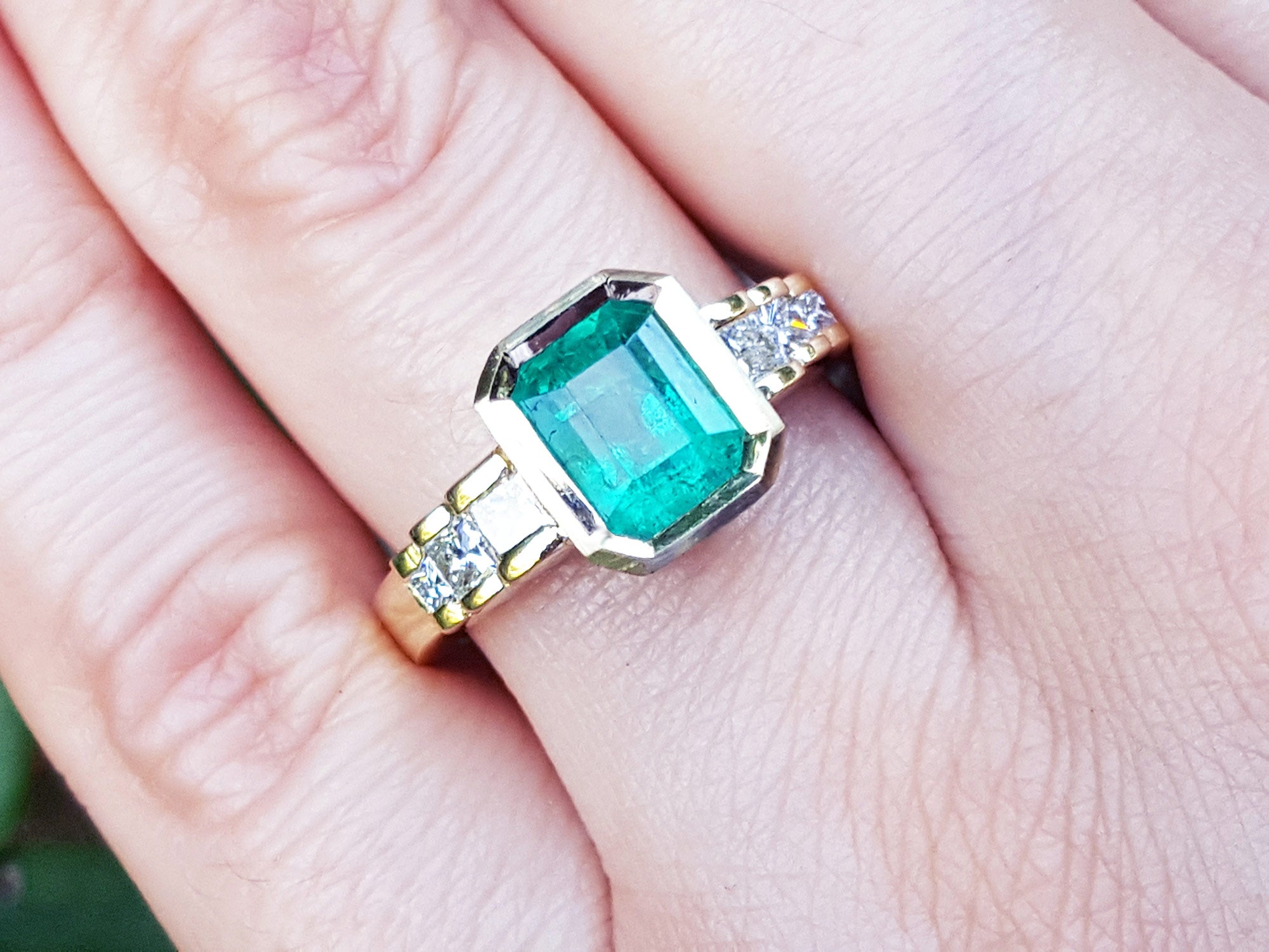 Women's emerald ring bezel set