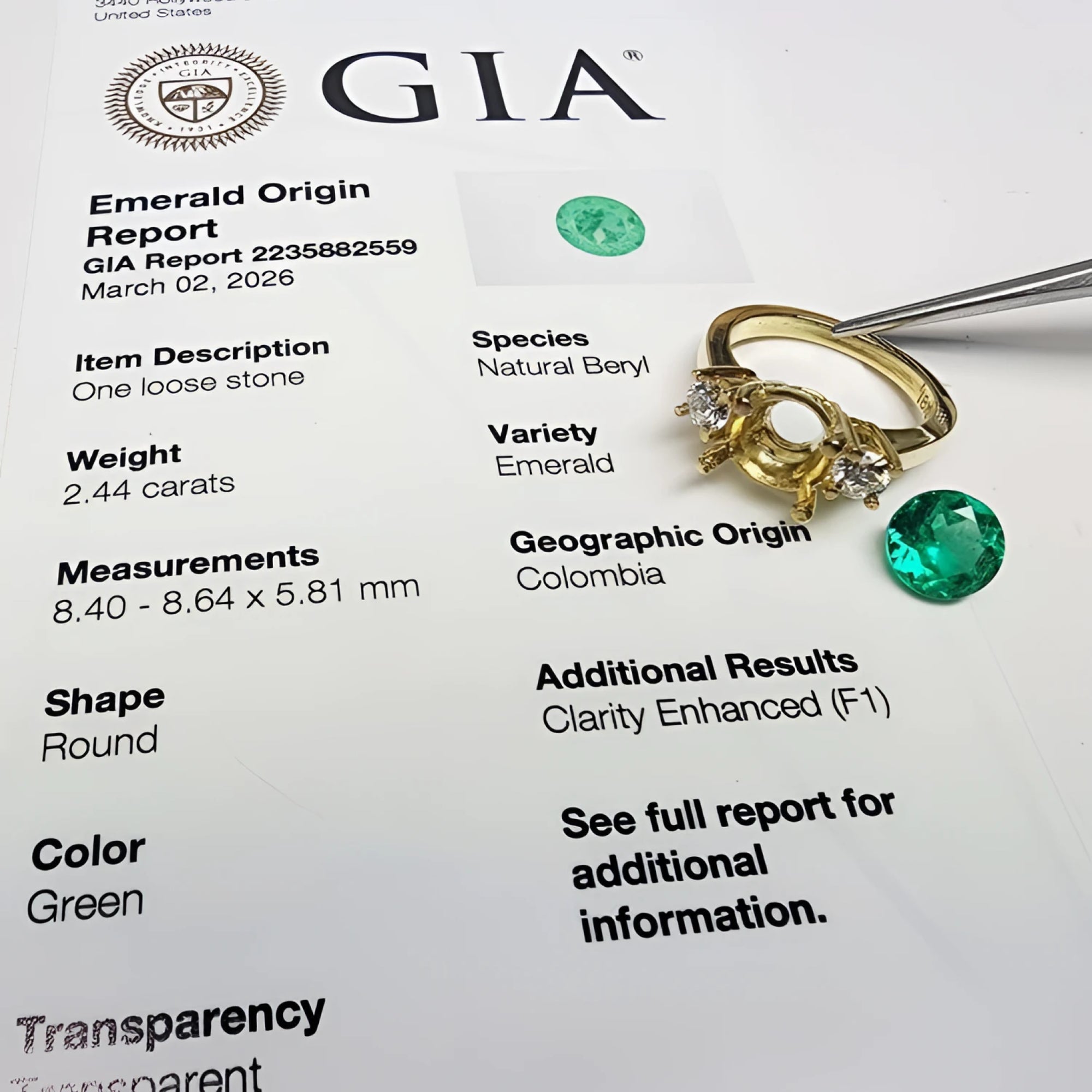 GIA certified 2.44 ct. round Colombian emerald, 18K yellow gold three-stone ring setting with accent diamonds.