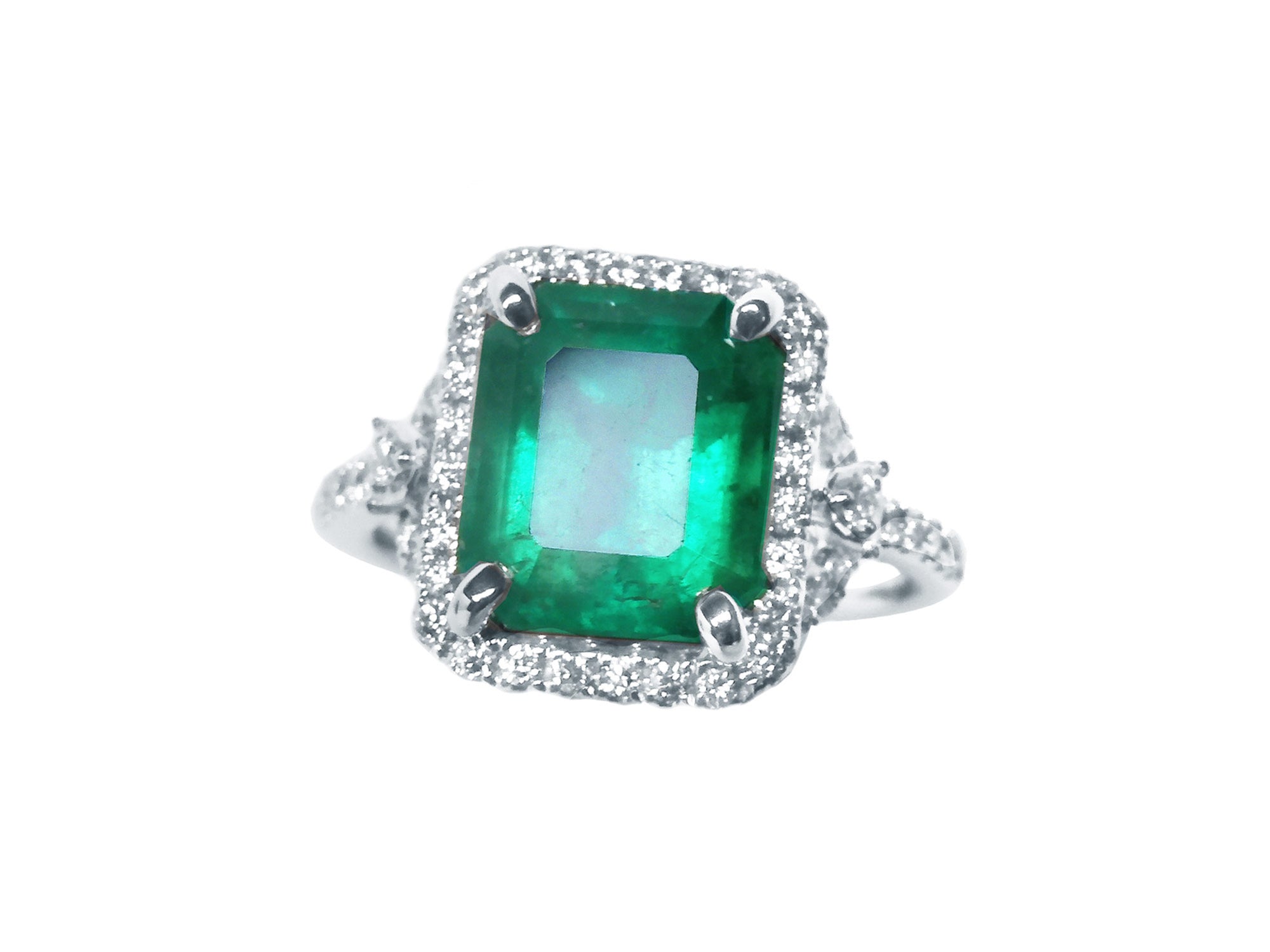 Halo diamond engagement ring with emerald
