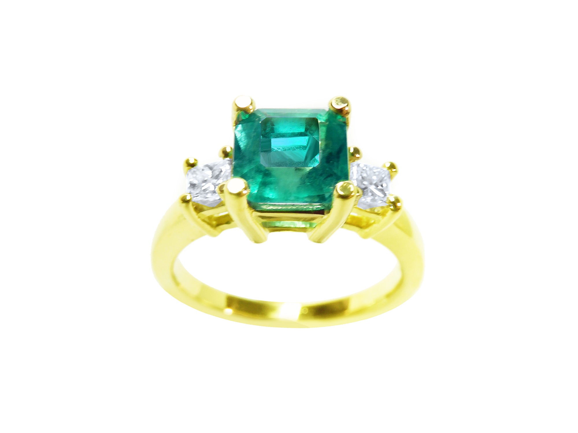 Emerald-cut three stone emerald ring