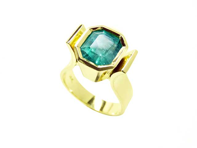 Women’s emerald and gold solitaire rings