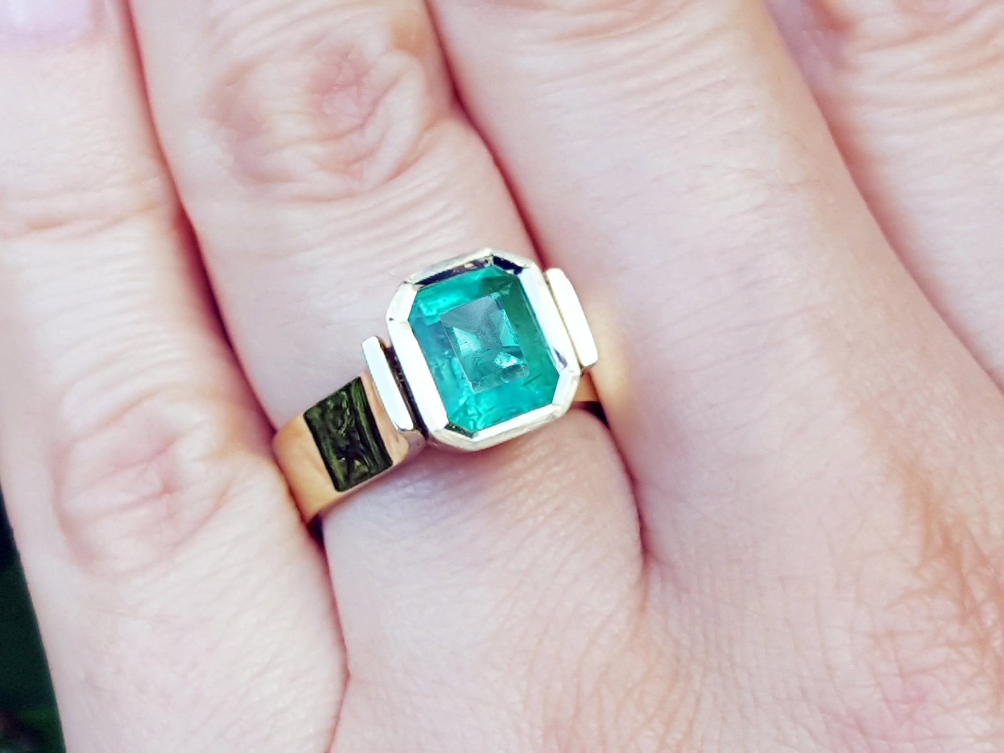 Women's solitaire emerald ring
