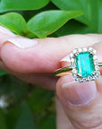 Halo emerald-cut Colombian emerald ring