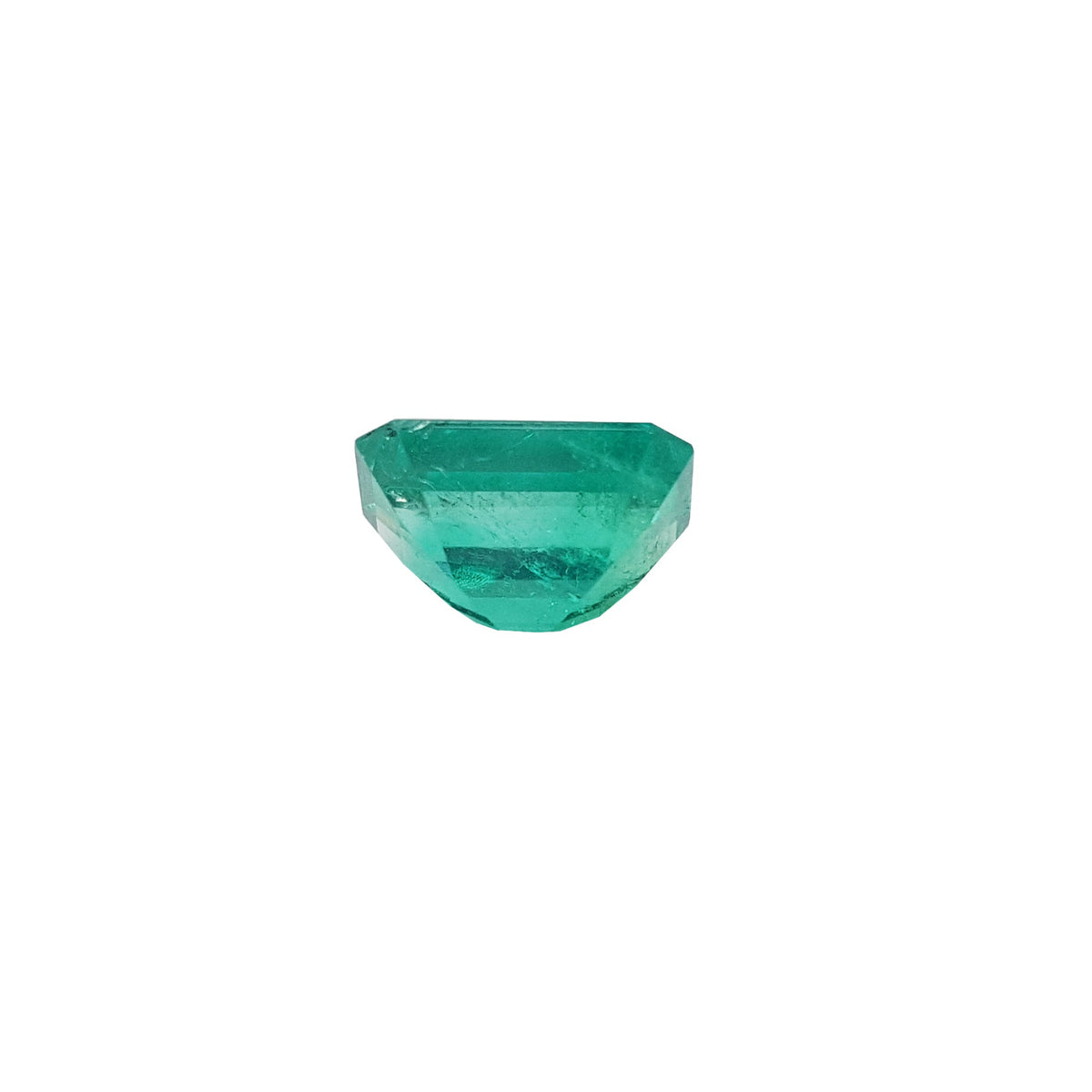 Natural loose colombian emerald displaying the underside.