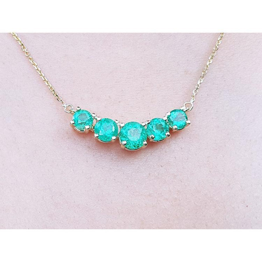 14K gold necklace with five round, medium green Colombian emeralds in elegant basket settings.