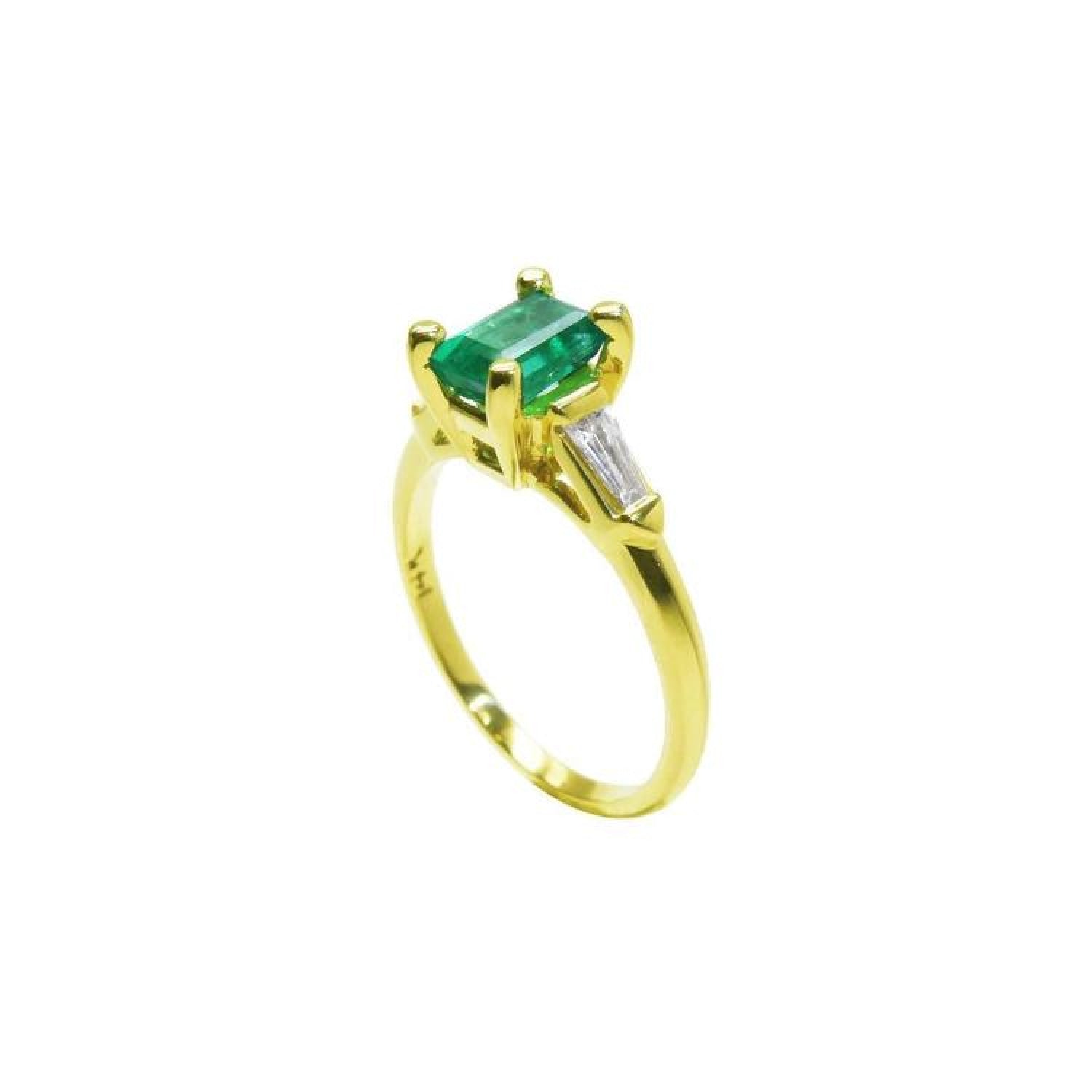 14K yellow gold ring with a rectangular emerald and baguette side diamonds.