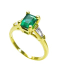 The tilted position of this emerald ring shows the top gemstone, side diamond and band profile.