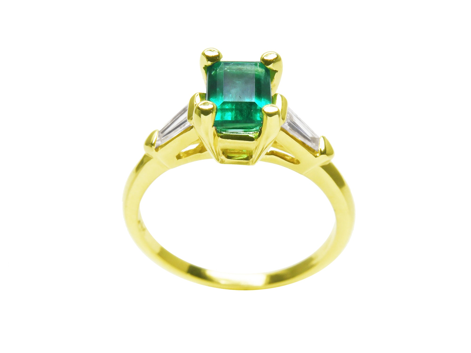 A yellow gold emerald ring displaying its lateral profile, top and gallery view.