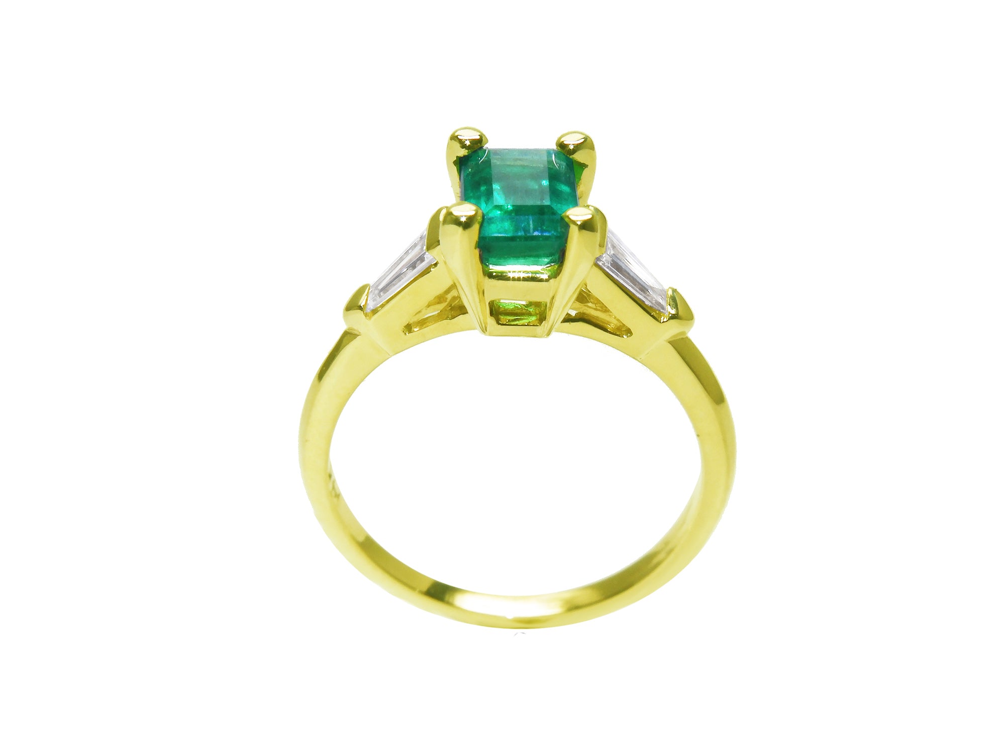This yellow gold emerald ring shows the top and gallery with the band ring.