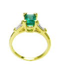 This yellow gold emerald ring shows the top and gallery with the band ring.