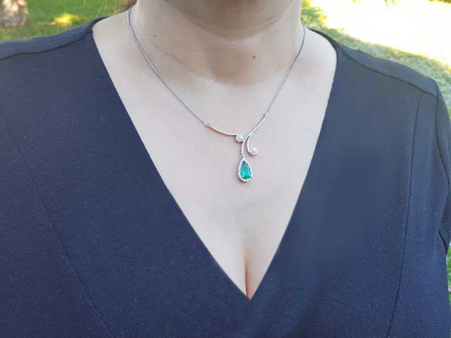 Pear shaped emerald necklace with halo diamonds