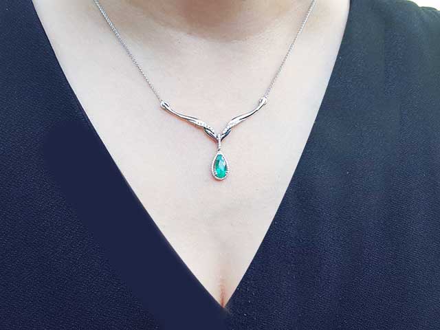 Solid white gold emerald and diamond necklace