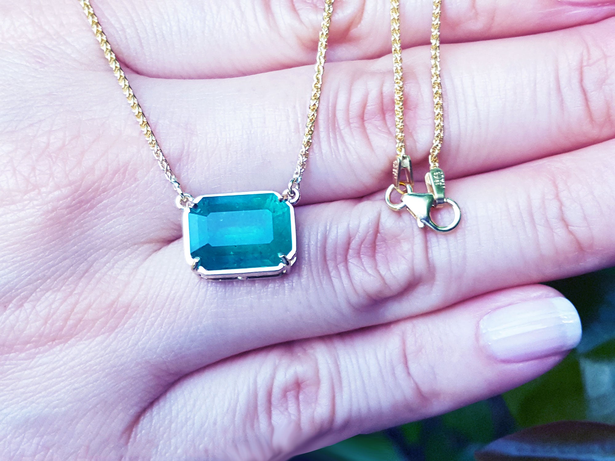 Solitaire gold necklaces with emeralds