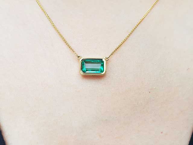 Solitaire bezel set emerald necklace