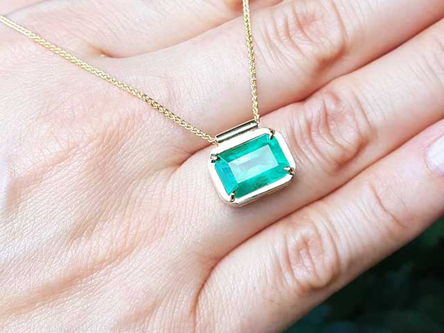 Yellow gold emerald solitaire necklace