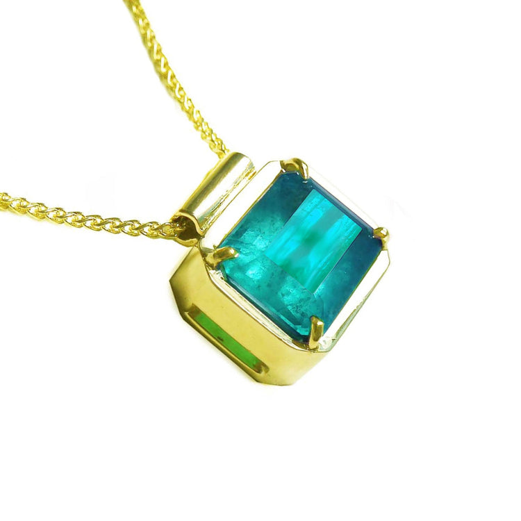 Emerald solitaire necklace east west orientation emerald-cut rectangular natural prong set in a handmade setting 18k yellow gold