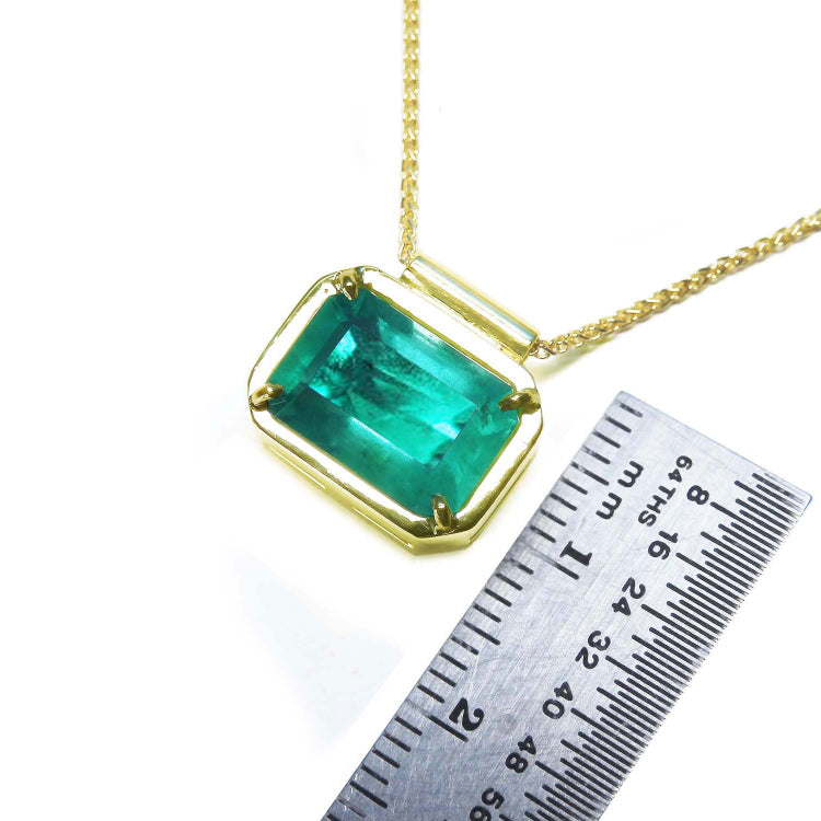 Women&#39;s Emerald solitaire necklace east west orientation emerald-cut prong set in a handmade setting in 18k yellow gold