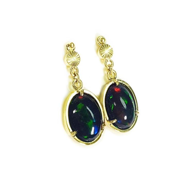 Ethiopian Welo black opal oval earrings with bluish green and red-orange fire, set in 14K yellow gold.