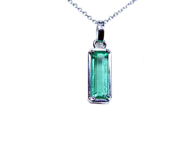 Emerald pendant with halo diamonds