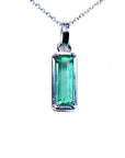 Emerald pendant with halo diamonds