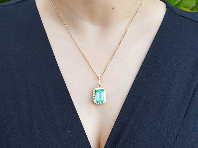 Emerald-cut halo emerald pendant