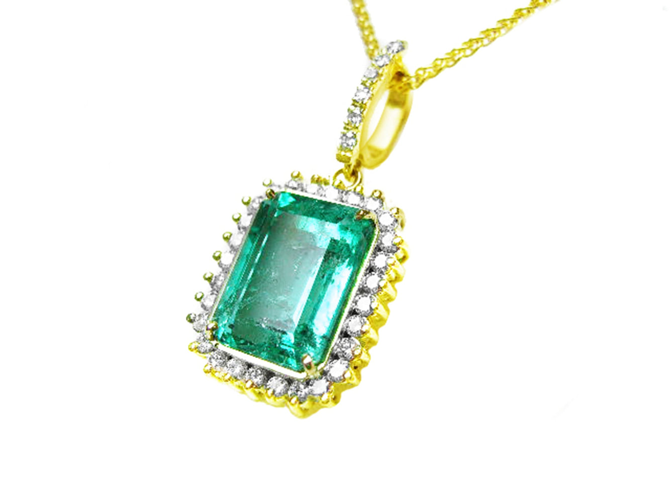 Gold pendant with a square natural emerald and diamonds on a white background.