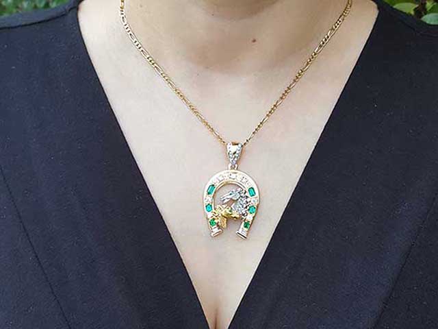 Emerald and diamond horseshoe pendants