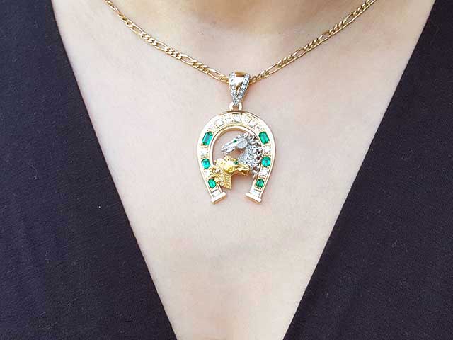 Emerald dangling horseshoe pendant