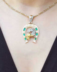 Emerald dangling horseshoe pendant