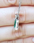 Solid white gold pendant with emeralds