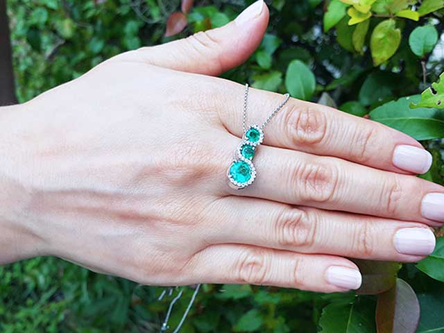 Emerald and diamond jouerney pendant necklace