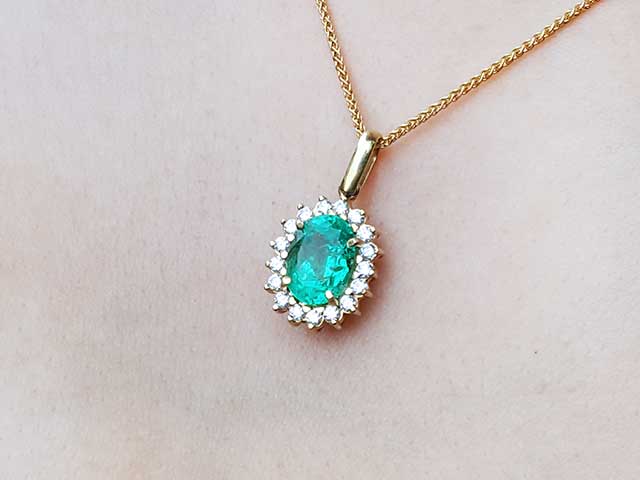 Solid gold emerald and diamond pendant necklace