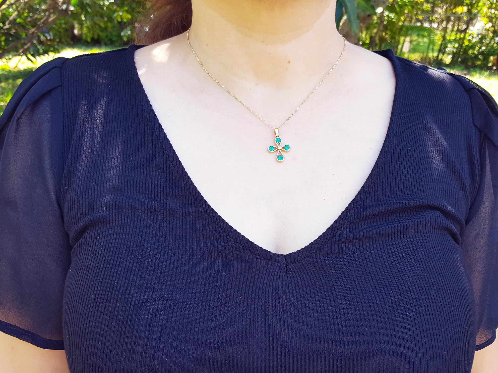 Yellow gold emerald cross necklace