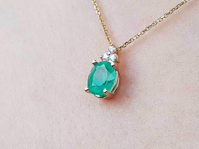 Real emerald and gold pendant