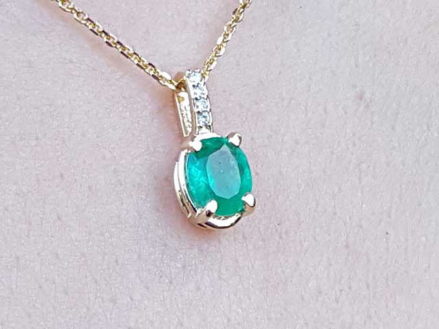 Solid gold emerald and diamond pendant